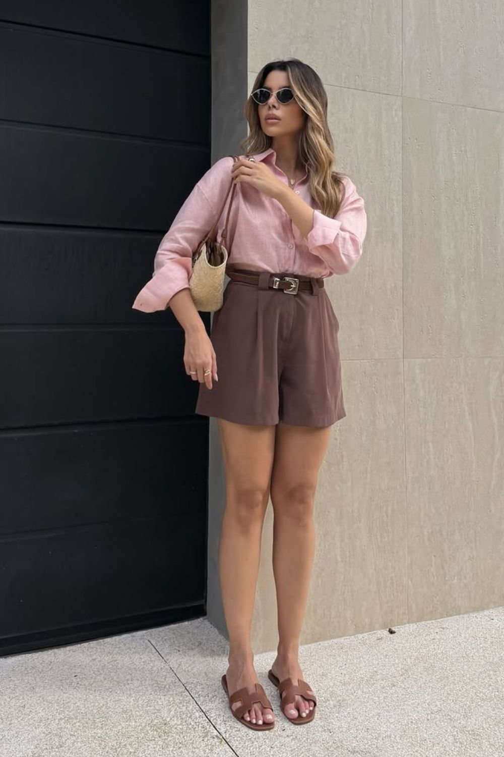 Como ser effortless chic em tons terrosos, camisa rosa, short de alfaiataria marrom, bolsa de palha e rasteirinha